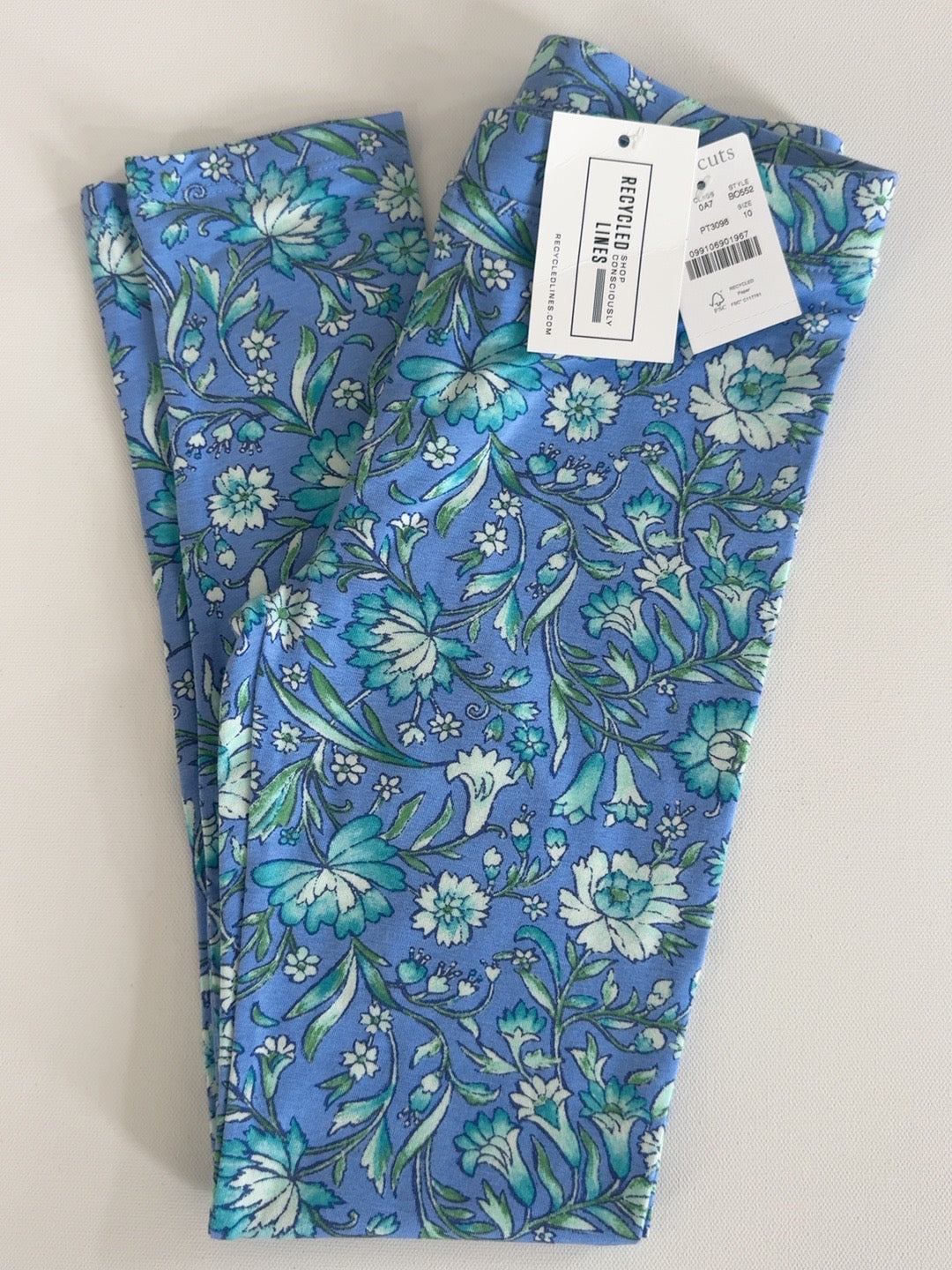 Crewcuts girls size 10 floral leggings in blue, teal and green, folded front view