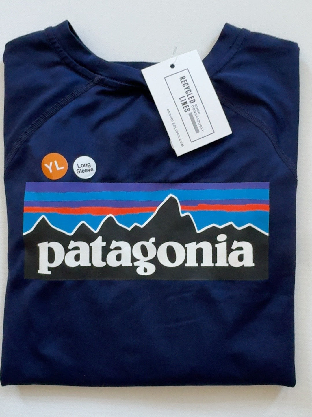 Patagonia navy long sleeve rash guard boys size L (12), folded front view