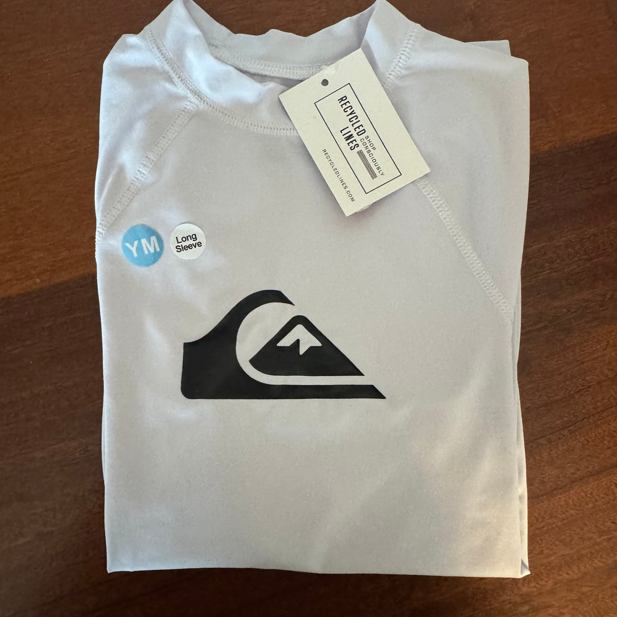Quiksilver white boys medium long sleeve rashguard with black mountain wave logo