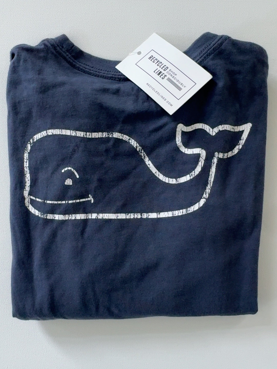 Original product photo of navy Vineyard Vines boys whale graphic tee with distressed white whale logo