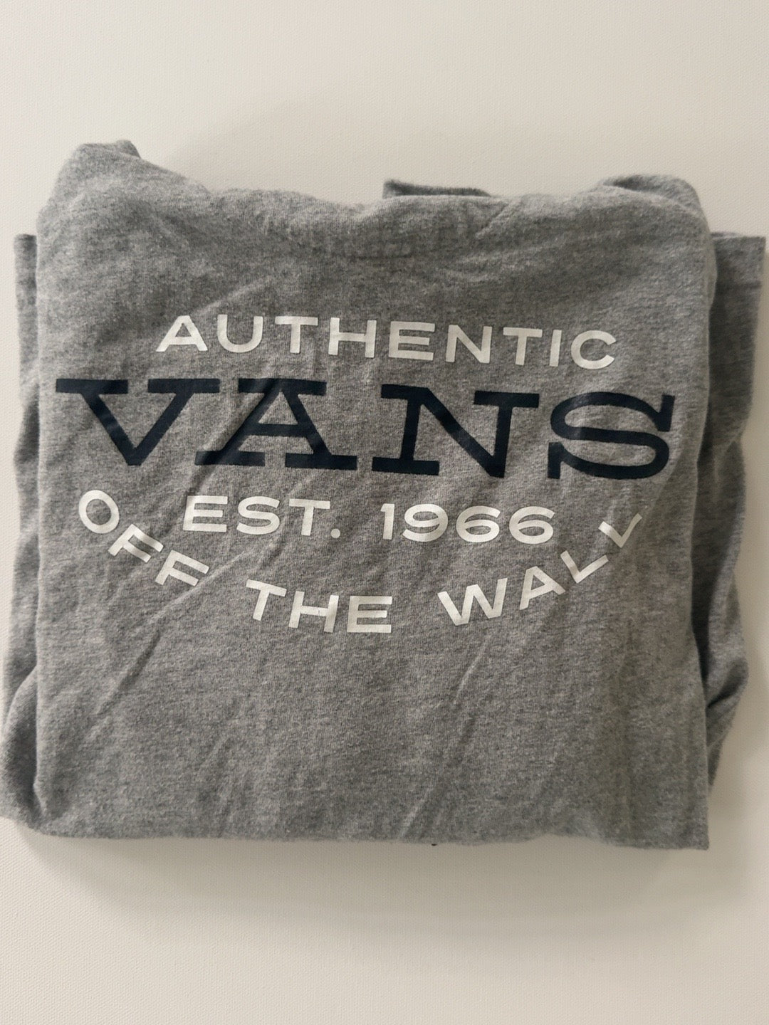 Vans gray hooded long sleeve tee with Authentic Vans Off The Wall logo, folded front view