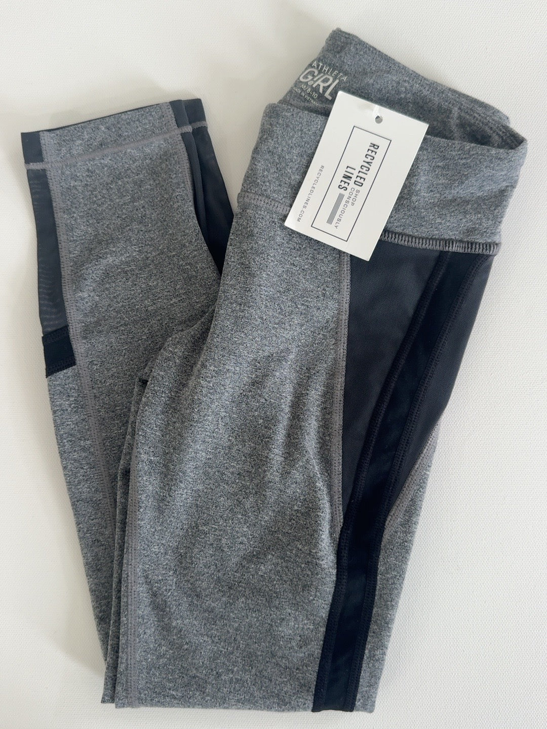 Athleta Girl heather gray leggings with black side panels, girls size M (8/10)