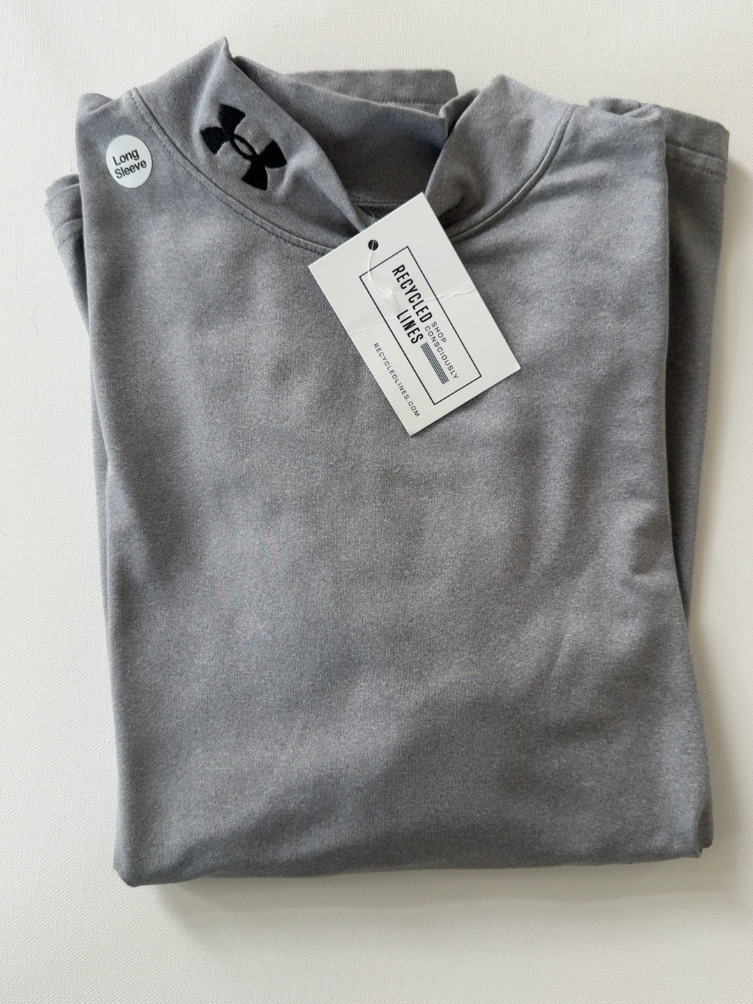 Original photo of gray Under Armour ColdGear long sleeve boys XL shirt with black collar logo