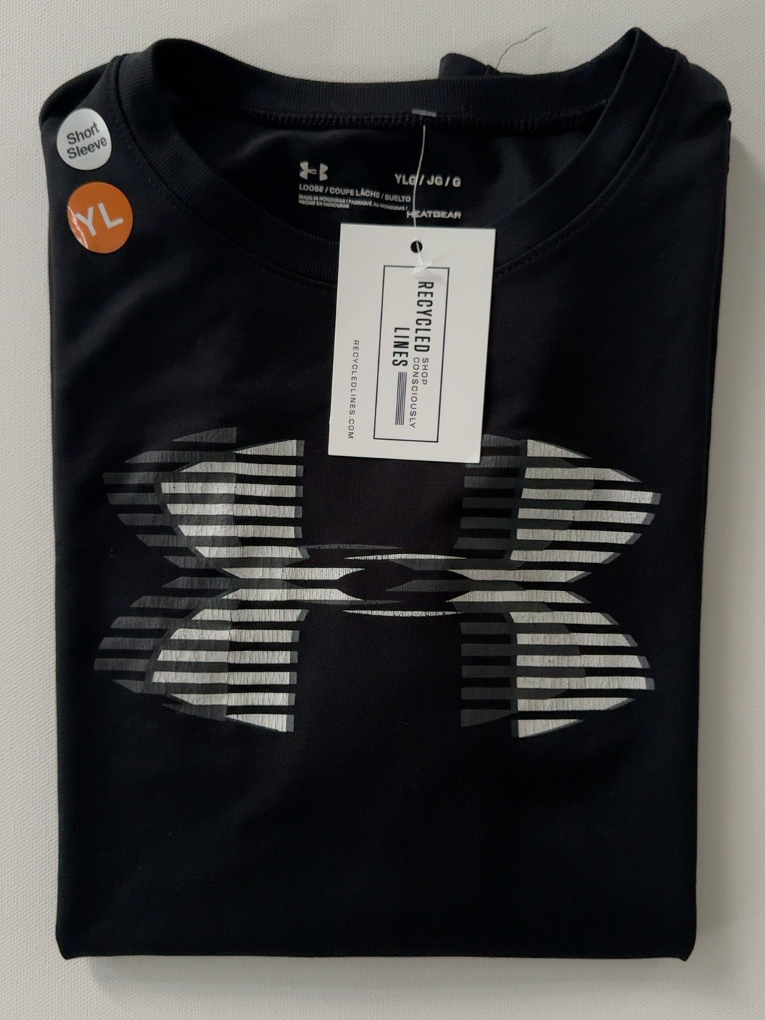 Under Armour black short sleeve boys size L tee with striped silver logo