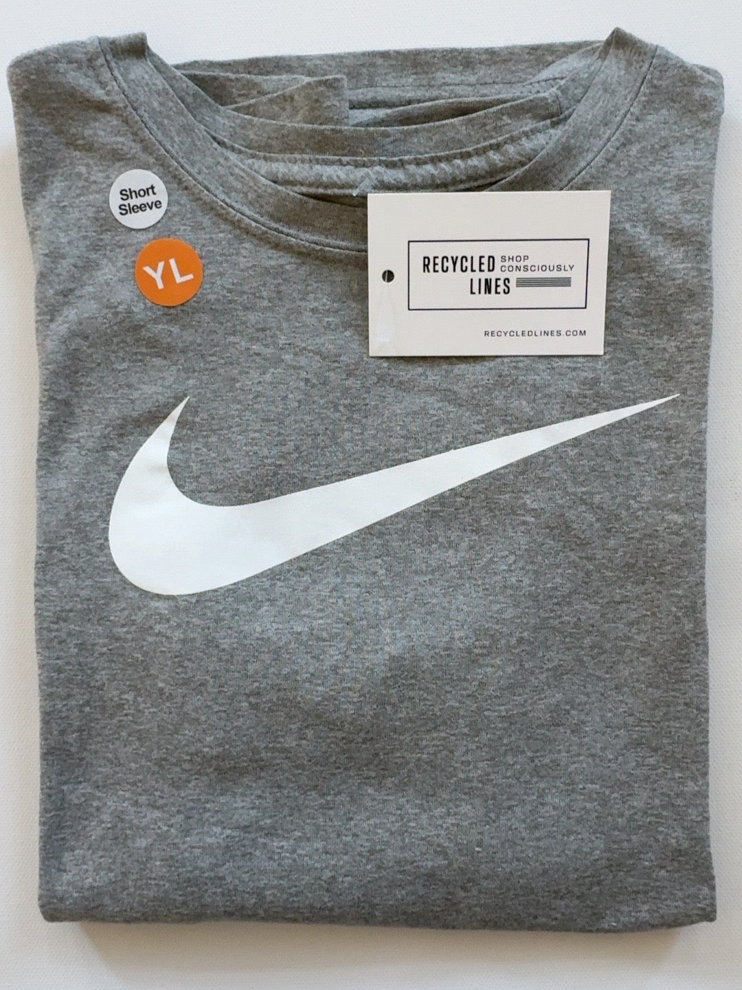 Nike gray short sleeve tee with white swoosh, boys size L, folded front view