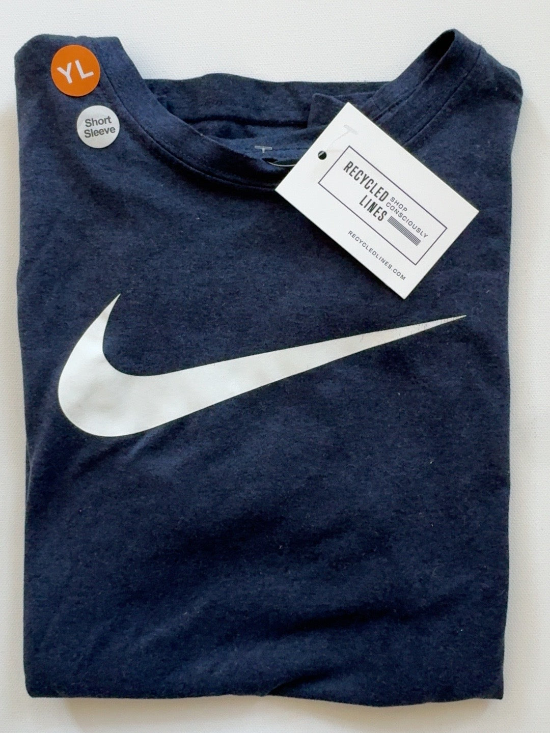 Nike navy short sleeve tee with white swoosh, boys size L, folded front view