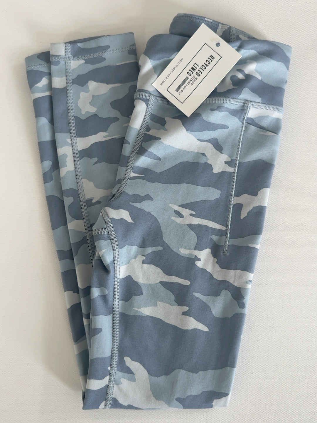 Athleta girls blue and gray camouflage leggings, size M (8/10), folded view